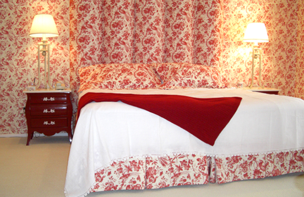A red and white Toile traditional pattern blended into something very quiet for this master bedroom.