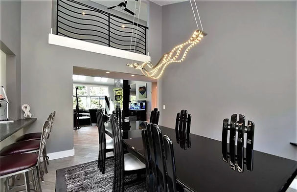 Dining area with contemporary lighting fixture